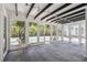 Bright sunroom with black beam ceilings, string lights and views of the backyard pool at 6503 N Wellington Ave, Tampa, FL 33604