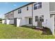 Townhome backyard featuring a well-maintained lawn and a white privacy fence at 7288 Deer Valley Circle, Tampa, FL 33635