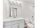 Bright bathroom featuring a white vanity, a large mirror, and a shower-tub combo with white subway tile at 7288 Deer Valley Circle, Tampa, FL 33635