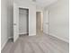 Cozy bedroom with gray carpet, featuring a closet with double doors and white trim throughout at 7288 Deer Valley Circle, Tampa, FL 33635