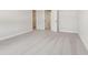 Bedroom with a walk-in closet featuring gray carpet, natural light, and neutral walls at 7288 Deer Valley Circle, Tampa, FL 33635
