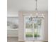 Chandelier-lit dining area with sliding door access to the backyard, offering a seamless indoor-outdoor flow at 7288 Deer Valley Circle, Tampa, FL 33635