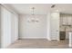 Bright dining room with wood floors, modern chandelier, and natural light from the sliding glass doors at 7288 Deer Valley Circle, Tampa, FL 33635