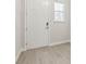 Bright entryway with wood-look tile flooring, white trim and a front door with modern hardware at 7288 Deer Valley Circle, Tampa, FL 33635