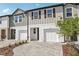 Attractive townhouses with neutral siding, one-car garage, and professionally landscaped front yards at 7288 Deer Valley Circle, Tampa, FL 33635