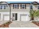 Charming townhouse with a brick paver driveway and a one-car garage, enhancing curb appeal at 7288 Deer Valley Circle, Tampa, FL 33635