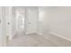 Hallway featuring light gray carpet, neutral walls, and white trim at 7288 Deer Valley Circle, Tampa, FL 33635
