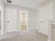 Upstairs hall with multiple doors including access to a walk-in closet and neutral carpet at 7288 Deer Valley Circle, Tampa, FL 33635