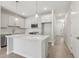 Bright kitchen with a central island, modern appliances, white cabinets, and sleek finishes at 7288 Deer Valley Circle, Tampa, FL 33635