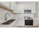 Well-appointed kitchen with stainless steel appliances, white cabinets, and a stylish tile backsplash at 7288 Deer Valley Circle, Tampa, FL 33635