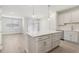 Open concept kitchen and dining area with an island, modern lighting, and access to the outdoors at 7288 Deer Valley Circle, Tampa, FL 33635