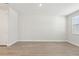 Spacious living room with wood-look flooring, neutral walls, bright windows, and a crisp white trim at 7288 Deer Valley Circle, Tampa, FL 33635