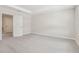 Bedroom with gray carpeting, tray ceiling, and ensuite access at 7288 Deer Valley Circle, Tampa, FL 33635