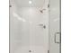 Modern shower with sleek subway tile, glass door, and rainfall shower head, offering a spa-like experience at 7288 Deer Valley Circle, Tampa, FL 33635