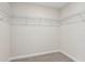 Spacious walk-in closet featuring carpet flooring and wire shelving for optimal organization and storage space at 7288 Deer Valley Circle, Tampa, FL 33635