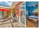 View of outdoor patio from the main bedroom with a relaxing seating area and ceiling fan at 14680 Linden Dr, Spring Hill, FL 34609