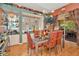 Dining room with glass table, patterned chairs, decorative shelving, and sliding glass doors to the patio at 14680 Linden Dr, Spring Hill, FL 34609