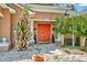 Close up of the front door surrounded by lovely shrubbery and lush foliage at 14680 Linden Dr, Spring Hill, FL 34609