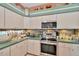 Well-equipped kitchen with stainless steel appliances, and ample countertop space at 14680 Linden Dr, Spring Hill, FL 34609
