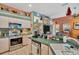 Well-lit kitchen featuring stainless steel appliances, tiled flooring, and spacious countertop areas at 14680 Linden Dr, Spring Hill, FL 34609