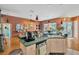Bright kitchen open to the living room with custom cabinetry and appliances at 14680 Linden Dr, Spring Hill, FL 34609