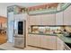 Kitchen featuring stainless steel refrigerator, light cabinets, and stylish countertop decor at 14680 Linden Dr, Spring Hill, FL 34609
