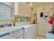 Laundry room with washer, dryer, sink, and storage cabinets at 14680 Linden Dr, Spring Hill, FL 34609