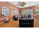 Spacious living room with hardwood floors, custom ceiling fan, comfortable seating, and pool views at 14680 Linden Dr, Spring Hill, FL 34609