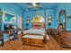 Bedroom with four-poster bed, desk area, and beautiful blue walls at 14680 Linden Dr, Spring Hill, FL 34609