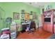Bright home office with hardwood floors, a comfortable desk area and decorative shelving at 14680 Linden Dr, Spring Hill, FL 34609