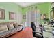 Bright home office with hardwood floors, a comfortable futon, and a desk area with natural light at 14680 Linden Dr, Spring Hill, FL 34609