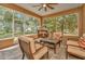 Screened-in patio with outdoor furniture, offering a relaxing space with views of the landscaped yard at 14680 Linden Dr, Spring Hill, FL 34609