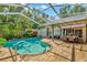 Backyard with a screened-in pool, patio, and outdoor dining area at 14680 Linden Dr, Spring Hill, FL 34609