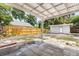 Backyard with covered patio, shed, and wooden fence at 1465 Pierce St, Clearwater, FL 33755