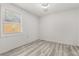 A bright bedroom featuring a window and vinyl plank flooring at 1465 Pierce St, Clearwater, FL 33755