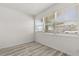 A bright bedroom featuring a window with natural light and vinyl plank flooring at 1465 Pierce St, Clearwater, FL 33755