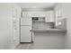 Light and airy kitchen with white cabinets, modern appliances and gray countertops at 1465 Pierce St, Clearwater, FL 33755