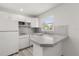 Bright white kitchen with modern appliances and a stylish backsplash at 1465 Pierce St, Clearwater, FL 33755