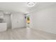 A simple kitchenette with white cabinets, sink, and an open doorway to the backyard at 1465 Pierce St, Clearwater, FL 33755