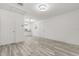 Open-concept living room with laminate wood flooring and neutral paint colors at 1465 Pierce St, Clearwater, FL 33755