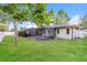 Spacious backyard with healthy green lawn and covered outdoor patio at 2006 Sycamore Ln, Plant City, FL 33563
