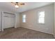 Bedroom featuring neutral walls, plush carpeting, closet, and natural light from two windows at 2006 Sycamore Ln, Plant City, FL 33563