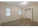 Bedroom featuring neutral walls, plush carpeting, closet, and natural light from windows at 2006 Sycamore Ln, Plant City, FL 33563