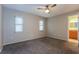 Spacious bedroom featuring neutral walls, plush carpeting, ceiling fan, and natural light at 2006 Sycamore Ln, Plant City, FL 33563