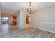 Open dining room with modern chandelier, hardwood floors and access to the kitchen at 2006 Sycamore Ln, Plant City, FL 33563