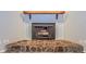 Close-up of a unique fireplace with a stone base and wooden mantel at 2006 Sycamore Ln, Plant City, FL 33563