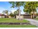 Charming single-story home with stone accents, mature trees, and a well-manicured lawn at 2006 Sycamore Ln, Plant City, FL 33563