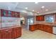 Open-concept kitchen featuring wood cabinets, granite countertops, and a view of the living area at 2006 Sycamore Ln, Plant City, FL 33563