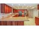 Well-lit kitchen featuring wood cabinets, granite countertops, and stainless steel appliances at 2006 Sycamore Ln, Plant City, FL 33563