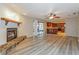 Open-concept living area showcasing hardwood floors, a cozy fireplace, and a view of the kitchen at 2006 Sycamore Ln, Plant City, FL 33563